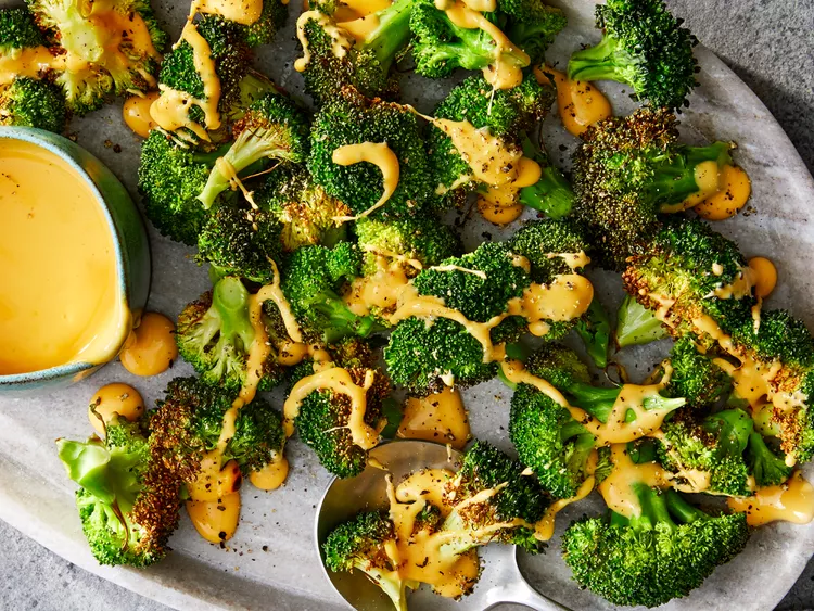 Air Fryer Broccoli Best quick restaurant-style Roasted broccoli florets seasoned with garlic and herbs on a baking sheet.