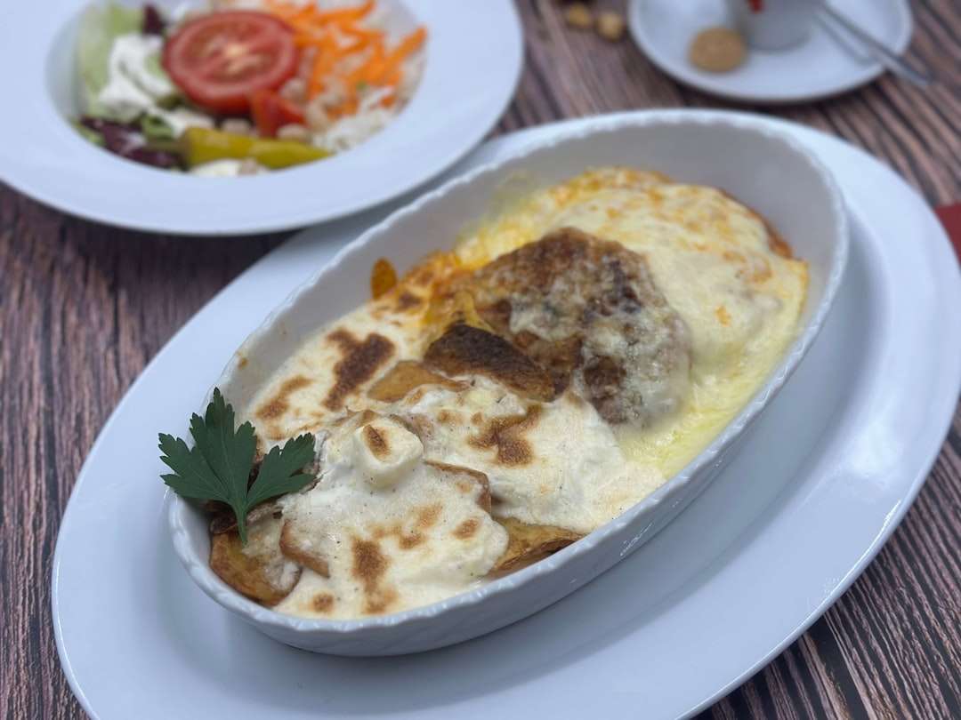 A slice of authentic Greek moussaka showing layers of eggplant, spiced meat, and bechamel