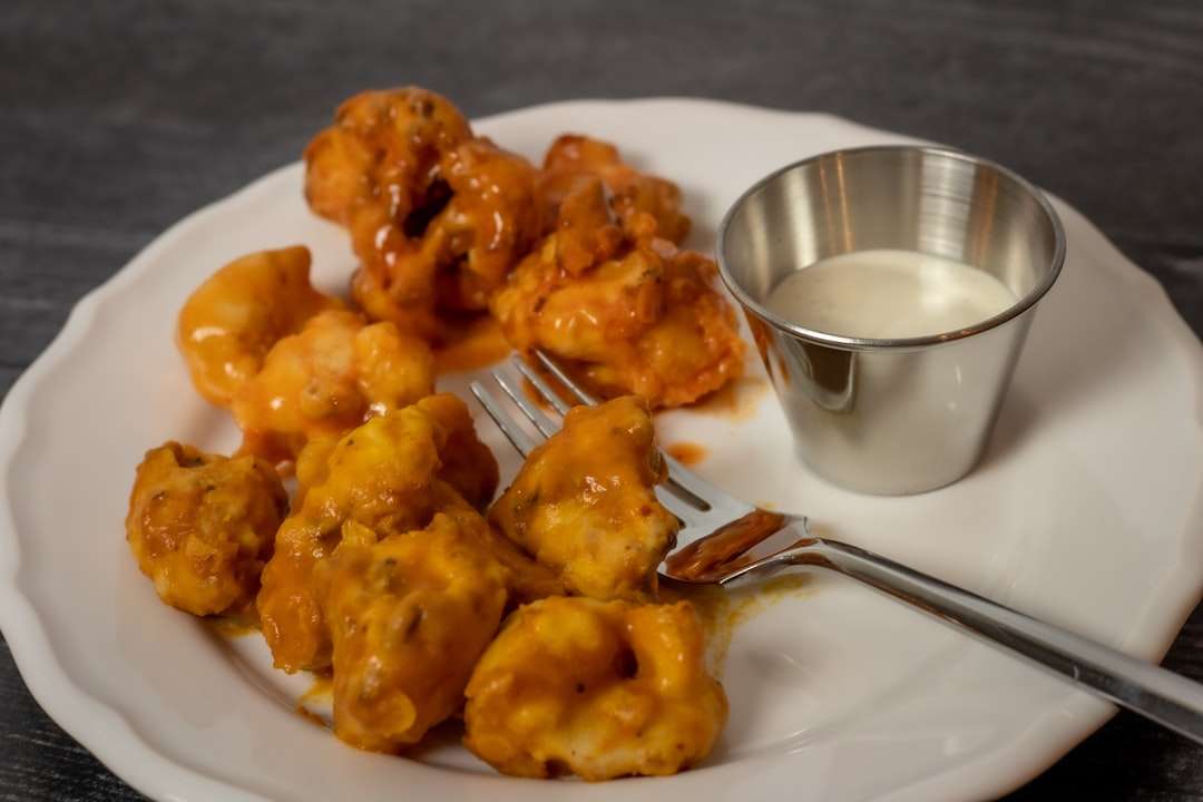 Crispy buffalo cauliflower bites served with a side of creamy ranch dipping sauce