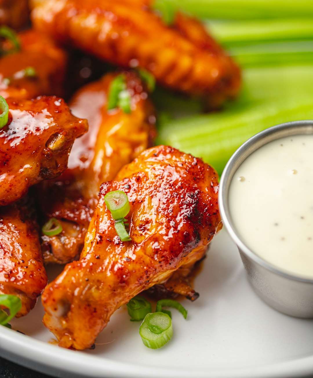 honey-sriracha-chicken-wings Crispy fried chicken tenders served with a side of white dipping sauce.