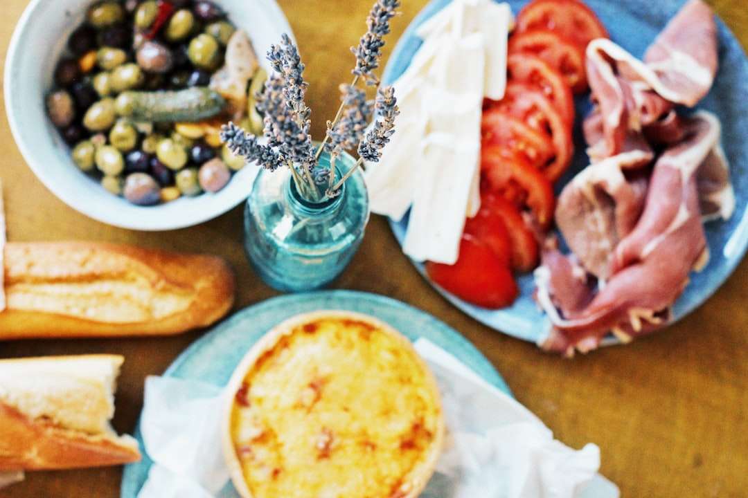 A traditional French antipasto platter with olives, fresh goat cheese, tomatoes, and cured meats