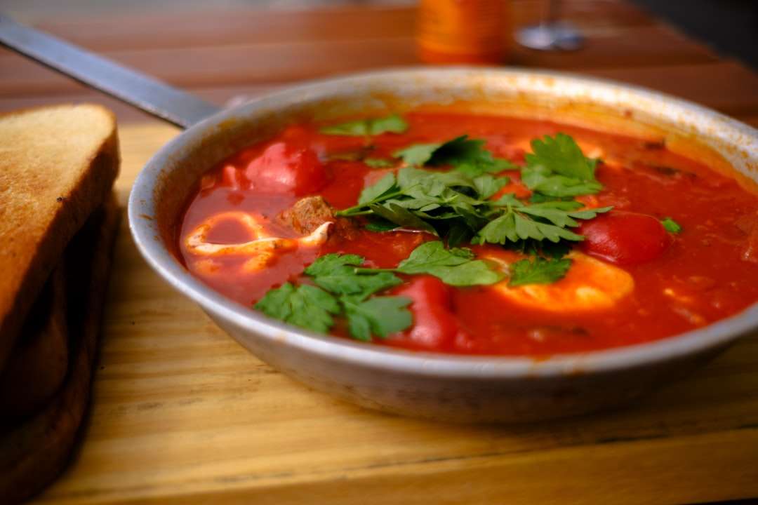 tomato-basil-soup Warm and comforting homemade tomato soup in a handle bowl with fresh basil garnish