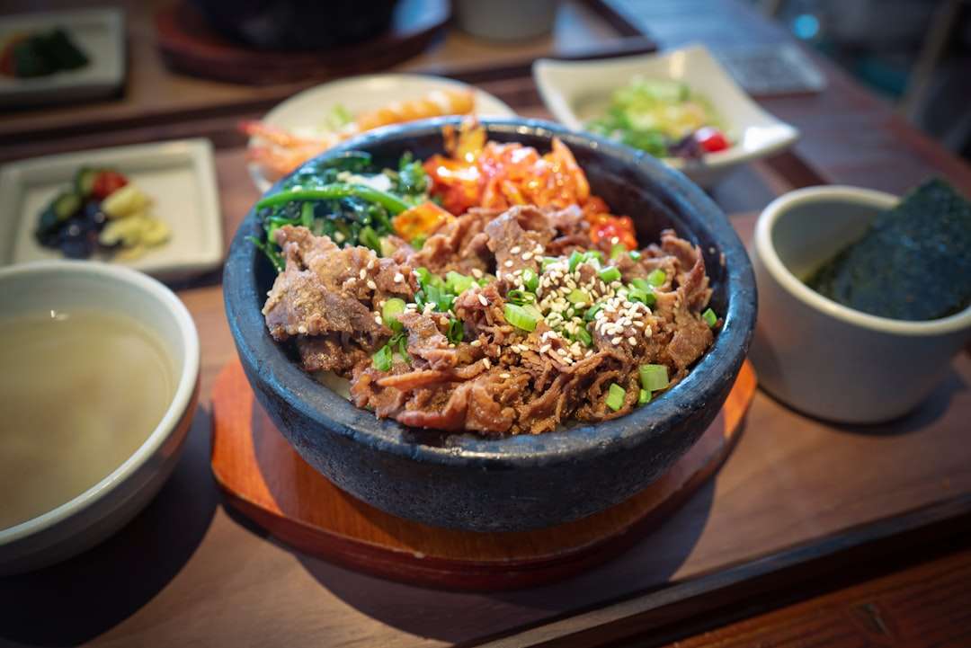 Korean beef bulgogi rice bowl served in a traditional hot stone pot bibimbap style Korean beef bulgogi rice bowl served in a traditional hot stone pot bibimbap style