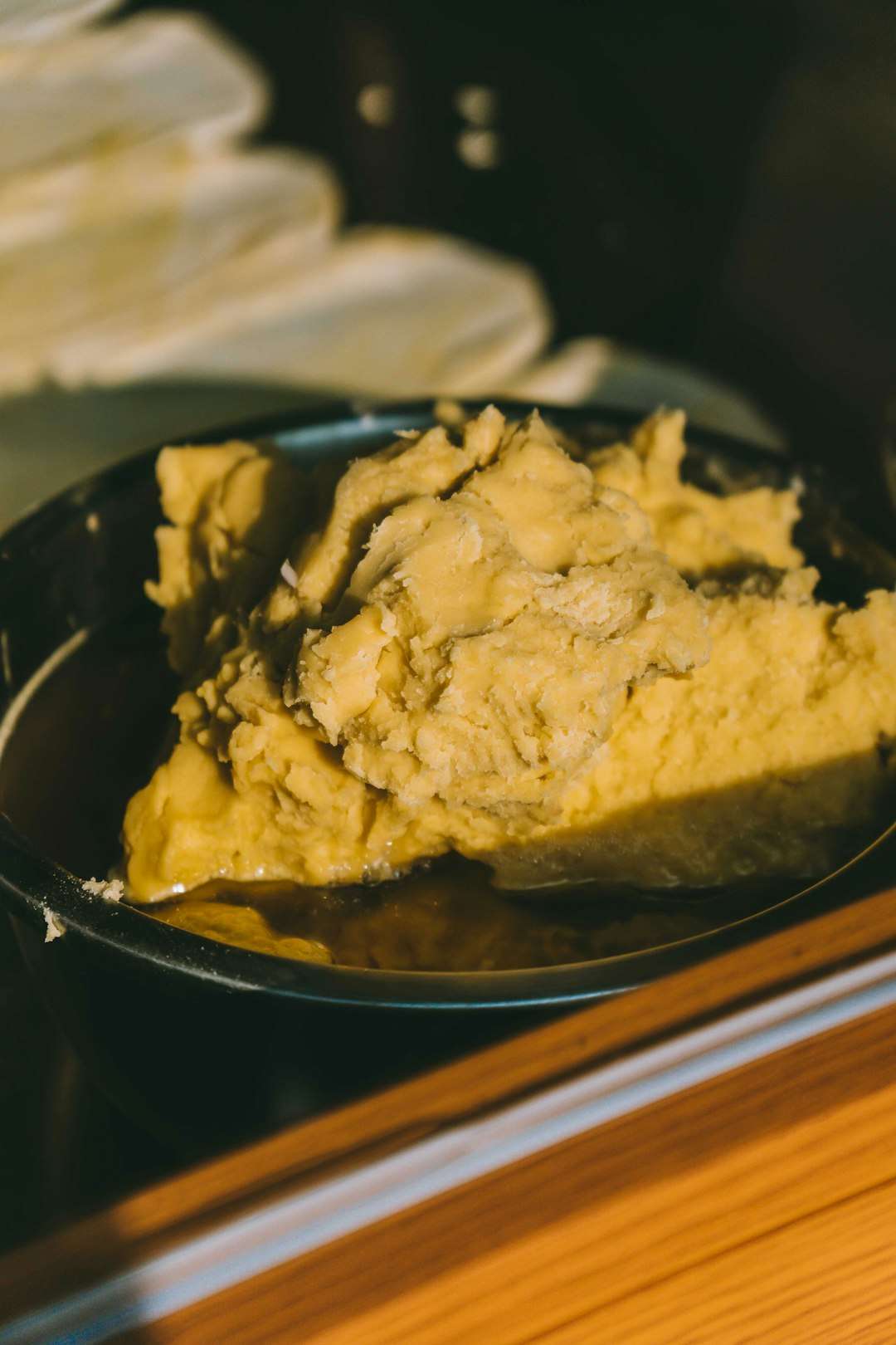 A close-up shot of creamy, golden mashed potatoes in a serving bowl A close-up shot of creamy, golden mashed potatoes in a serving bowl