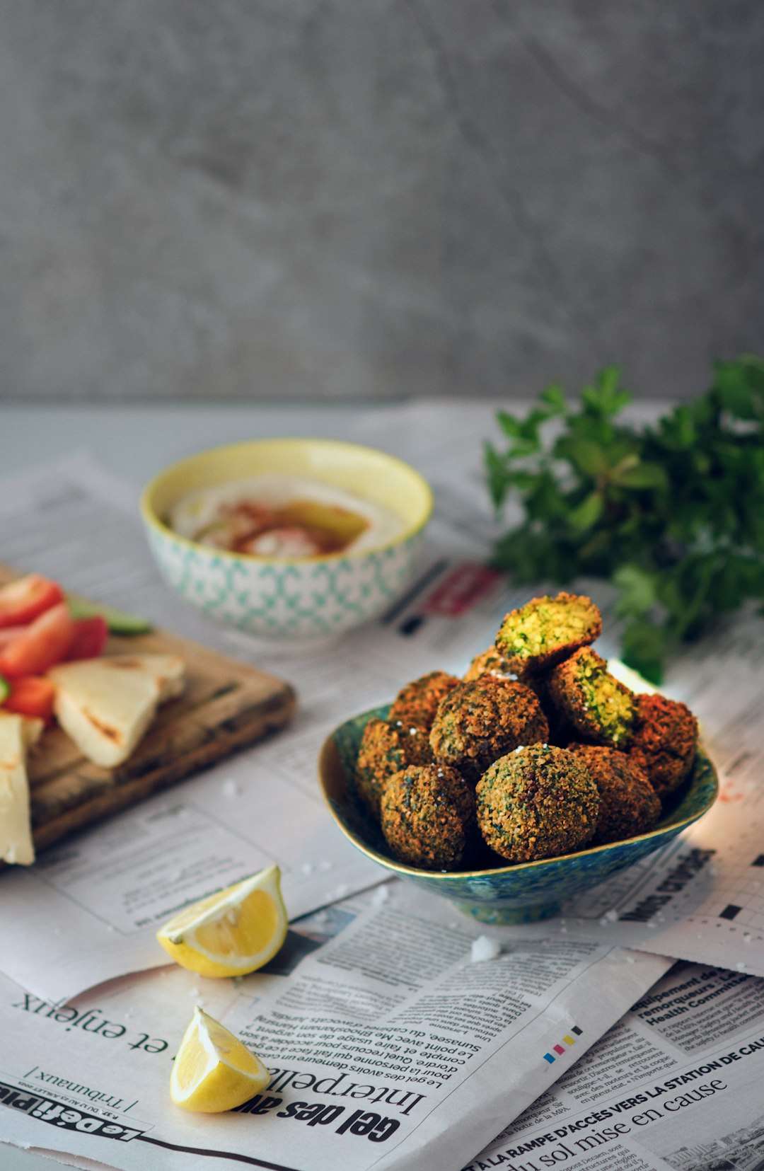 A healthy snack platter featuring falafel balls, hummus dip, and fresh sliced vegetables A healthy snack platter featuring falafel balls, hummus dip, and fresh sliced vegetables