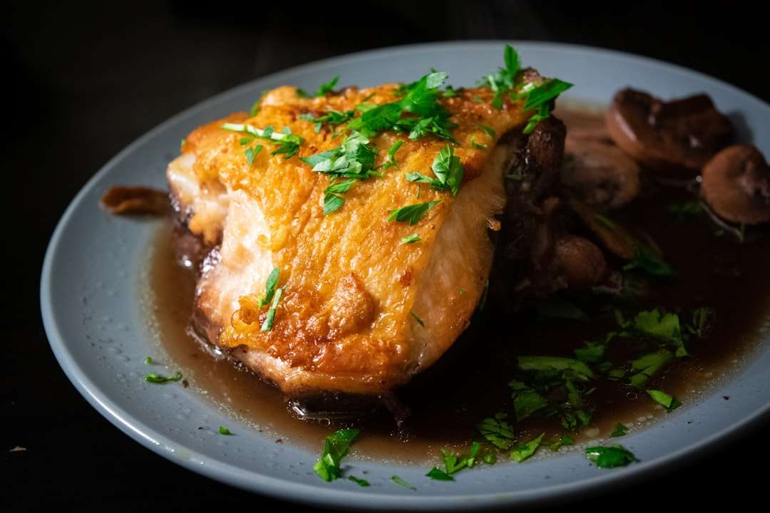undefined-20 Perfectly roasted chicken thigh with a golden crispy skin garnished with fresh herbs