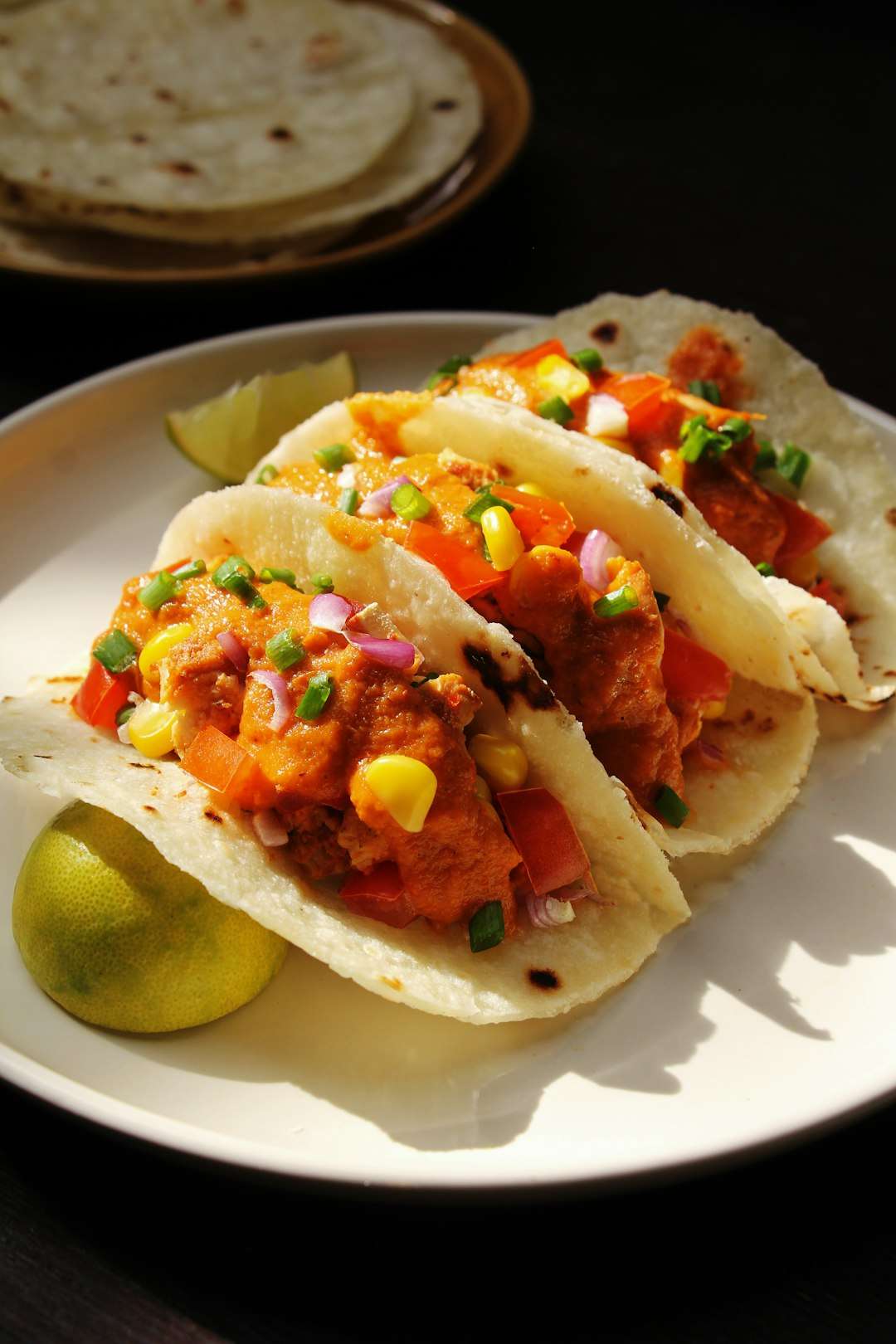 Three street Sweet Potato Tacos filled with seasoned meat, shredded cheese, and corn salsa Three street Sweet Potato Tacos filled with seasoned meat, shredded cheese, and corn salsa