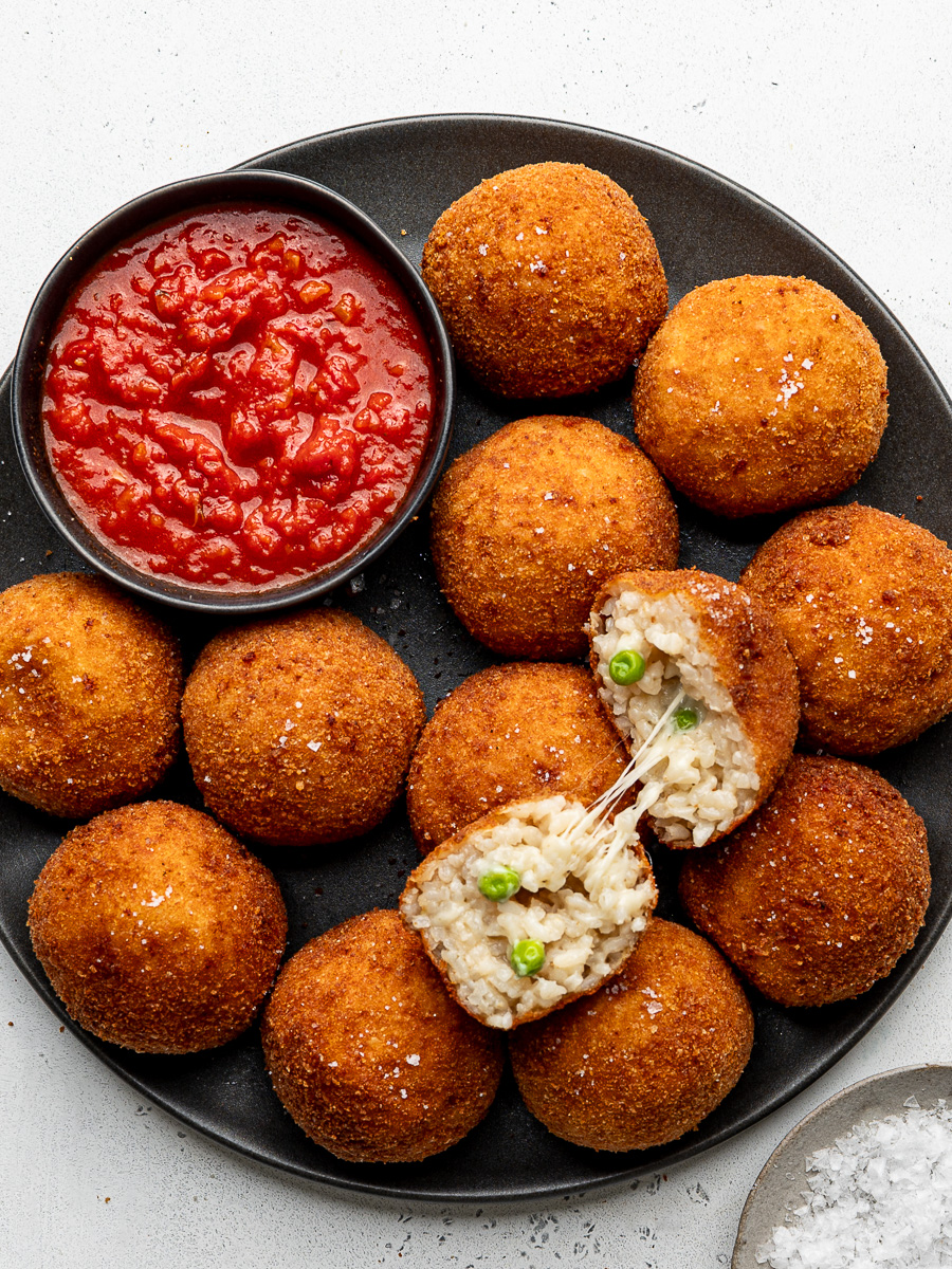 Melty Cheese Rice Arancini Best Match Night Snack Crispy deep-fried rice arancini balls with melted cheese fillings served with a side of savory tomato sauce
