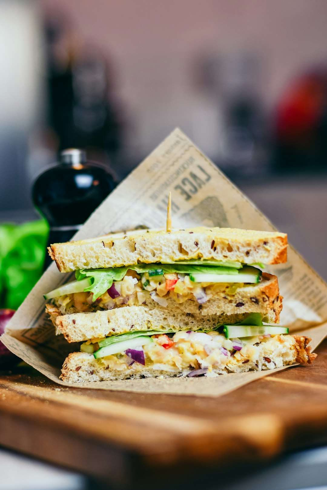 classic-tuna-melt-sandwich Toasted tuna melt sandwich with bubbly melted cheese wrapped in brown butcher paper