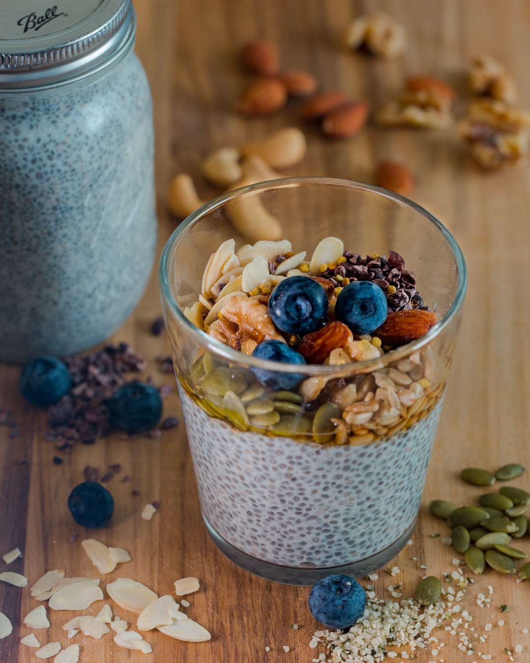 high-protein-chia-pudding-1 High protein chia seed pudding topped with fresh blueberries and oats in a glass