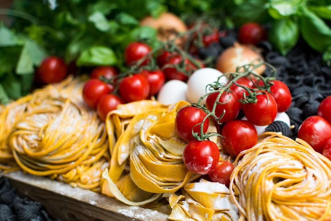 the-origins-of-italian-regional-cooking-traditions Fresh ingredients for traditional Italian cooking including vine tomatoes, eggs, and handmade pasta